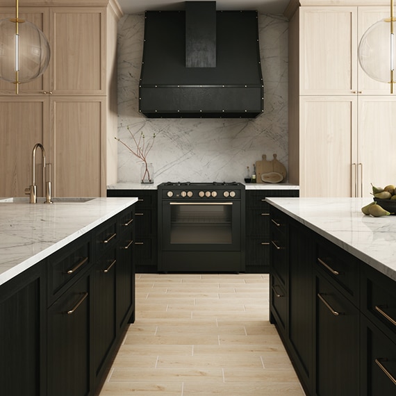 Modern kitchen with two islands, white marble with gray & beige veining countertops & backsplash, black lower cabinets, and natural wood upper cabinets.