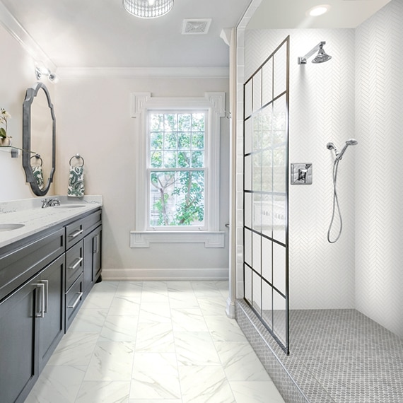Bathroom with marble look, 12x24, click tile flooring, marble countertop, and shower with white herringbone tile and gray hexagon tile shower floor.
