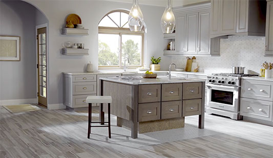 Modern kitchen with wood look flooring, white countertop, and sink.